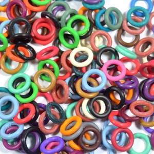 May include: A large assortment of colorful rubber rings in various sizes. The rings are made of a soft, flexible material and are perfect for crafts, jewelry making, and other projects.