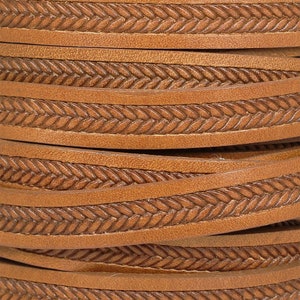 May include: Close-up of brown leather cord with a woven pattern. The cord is folded in layers, showing the detail of the design.