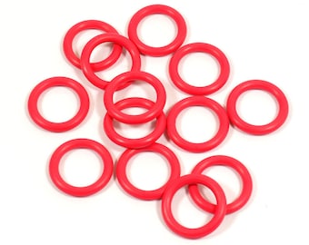 May include: A group of 12 bright red rubber O-rings. The rings are all the same size and are arranged in a random pattern.