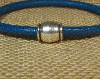 May include: A blue leather bracelet with a silver magnetic clasp.