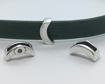 May include: Three silver metal clasps for leather straps. The clasps are shaped like a half-circle and have a small hole in the center.