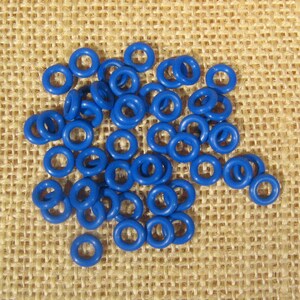 May include: A pile of blue rubber O-rings on a burlap background.