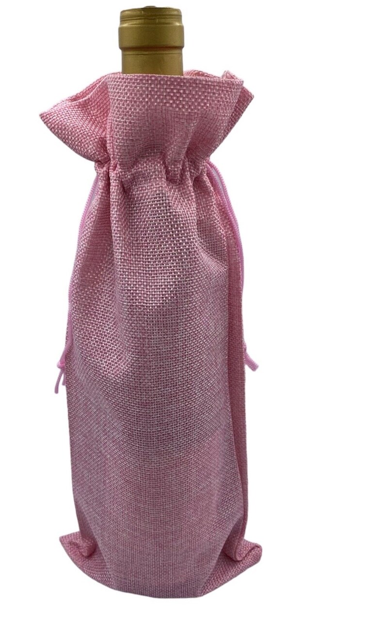May include: Pink burlap wine bottle bag with a drawstring closure.