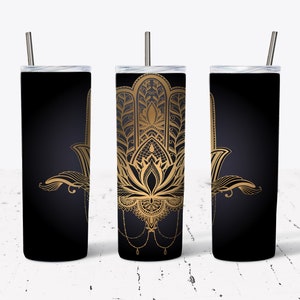 May include: Three stainless steel tumblers with a black background and a gold hamsa hand design. The hamsa hand is a symbol of protection and good luck.