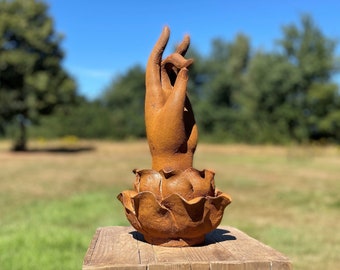 Hand of Buddha rises from a lotus flower - Garden sculpture