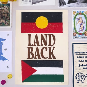 May include: A poster with the words "Land Back" printed in brown letters on a cream background. The poster features two flags, the Aboriginal flag and the Palestinian flag. The Aboriginal flag is black, red, and yellow with a yellow circle in the centre. The Palestinian flag is black, white, green, and red with a red triangle in the top left corner.