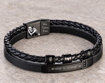 May include: A black multi-strand bracelet featuring a braided leather cord and a smooth leather band. It includes a metal clasp engraved with a photo of two people and the text We Love You, plus beads engraved with Eric, a heart, and Eva.