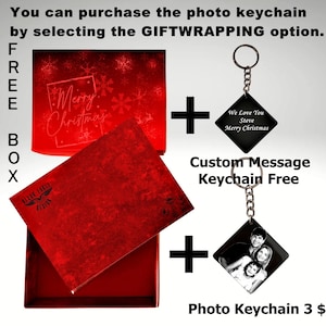 May include: A red gift box with a "Merry Christmas" design. A black photo keychain with a family photo and the text "Photo Keychain 3$" is shown. A black keychain with a custom message is also shown with the text "Custom Message Keychain Free".