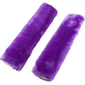 May include: Two purple faux fur seat belt shoulder pads. The pads are soft and plush and can be used to make driving more comfortable.