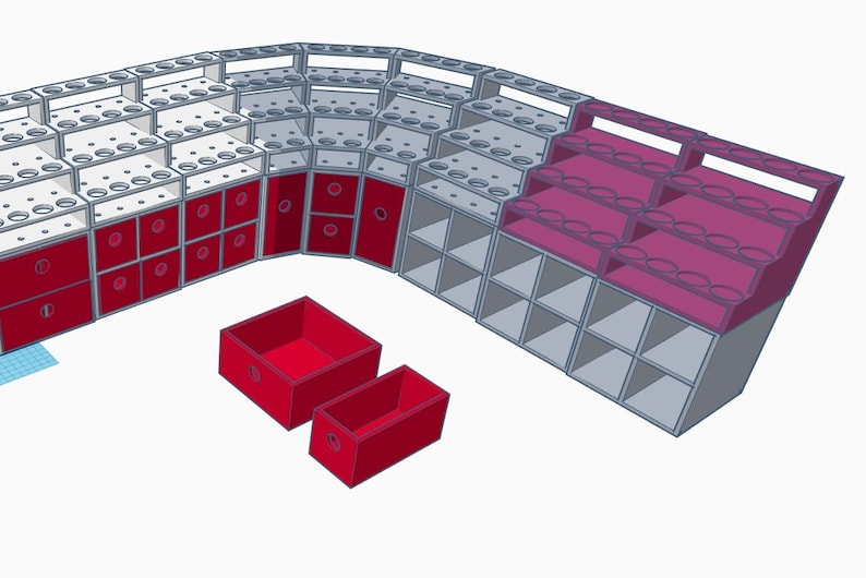 May include: A white and gray modular shelving unit with red drawers and boxes. The unit has multiple shelves and compartments for storage.