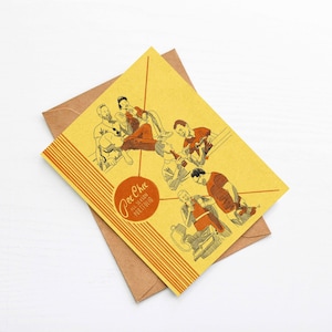 May include: A yellow card with a group of people illustrated in black and orange. The card has a striped pattern and the text "Pee-Chee All Season Portfolio" in a circle.