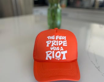 The first pride was a riot trucker hat : Orange