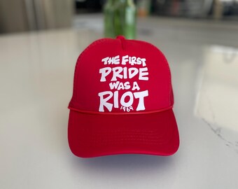 The first pride was a riot trucker hat : Red