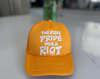 The first pride was a riot trucker hat : yellow