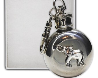 May include: A silver flask with an elephant design on the front. The flask has a screw-on cap and a metal loop for attaching to a keychain.
