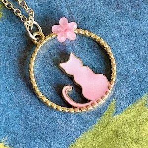 Pretty Pink Kitty Cat Sitting in a Gold Circle With a Pretty Pink