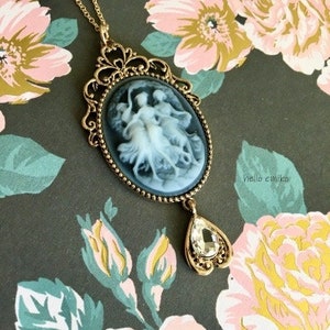 Beautiful 3 Muses Antique Vintage Style Cameo Pendant Necklace with White Jewel Heart Drop Charm On 18 Inch Gold Plated Chain Lobster Clasp