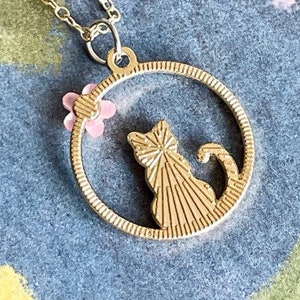 Pretty Pink Kitty Cat Sitting in a Gold Circle With a Pretty Pink