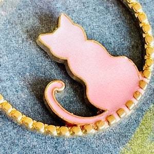 Pretty Pink Kitty Cat Sitting in a Gold Circle With a Pretty Pink