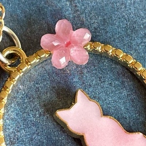 Pretty Pink Kitty Cat Sitting in a Gold Circle With a Pretty Pink