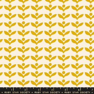 May include: Cream-colored fabric with a repeating pattern of stylized yellow floral shapes. Each floral element has two curved leaves and a central dot. The bottom edge features a black ruler with the text "RUBY STAR SOCIETY".