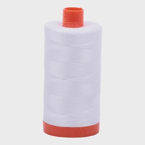 May include: A spool of white thread with an orange top and bottom. The thread is tightly wound around the spool, creating a cylindrical shape. The orange top and bottom provide a contrasting color to the white thread.