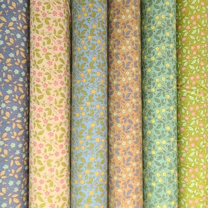 May include: A collection of 10 fabric rolls with a floral pattern. The fabric is a light weight cotton with a variety of colors including pink, orange, blue, green, and yellow.