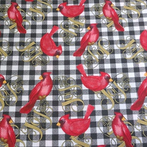 May include: Black and white checkered fabric with a repeating pattern of red cardinals and the word "Joy" in gold script.