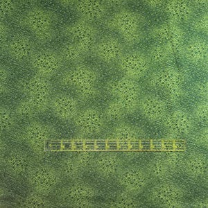 May include: Green fabric with a subtle, speckled pattern. The fabric has a slightly textured surface.