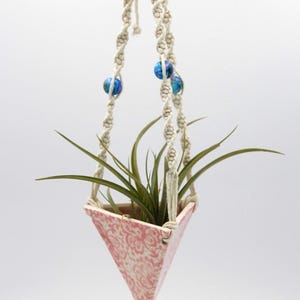 Pyramid-shaped hanging air plant pot with pink lace, turquoise beads, and a macrame cord
