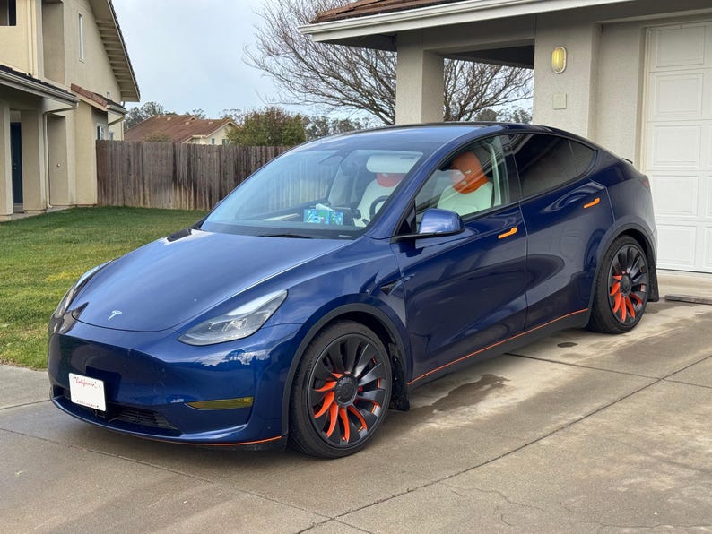 Model Y side profile with orange spokes