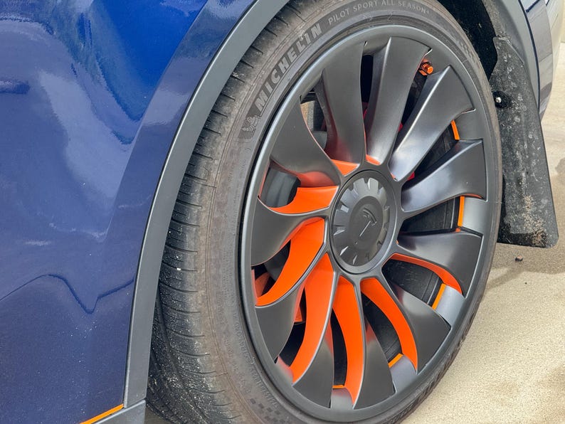 21-inch Uberturbine wheel with orange Turbine Tats vinyl accents on the spokes