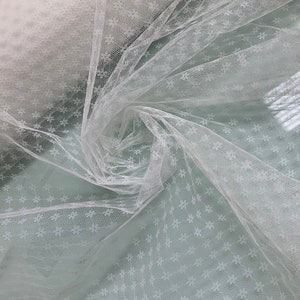 Beautiful ivory color Russian net 48” wide. Best used for bridal wear and hat making. Sold by the yard