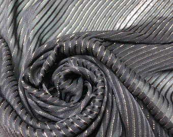 May include: Black fabric with thin gold stripes. The fabric is pleated and has a soft, flowing texture.