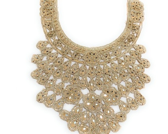May include: A gold-colored, ornate collar with intricate beadwork and embellishments. The collar features a curved neckline and a detailed, symmetrical design with teardrop-shaped accents. The overall aesthetic is elegant and decorative, suitable for embellishing garments.