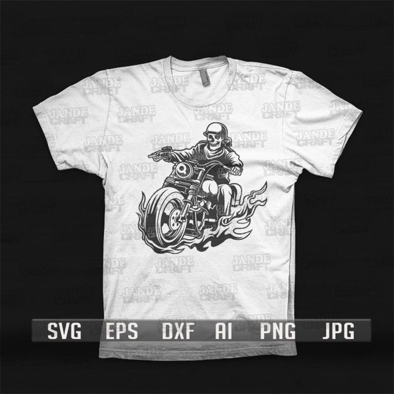 May include: A white t-shirt with a black and white illustration of a skeleton riding a motorcycle with flames coming from the wheels. The text "JADE CRAFT" is repeated in the background.