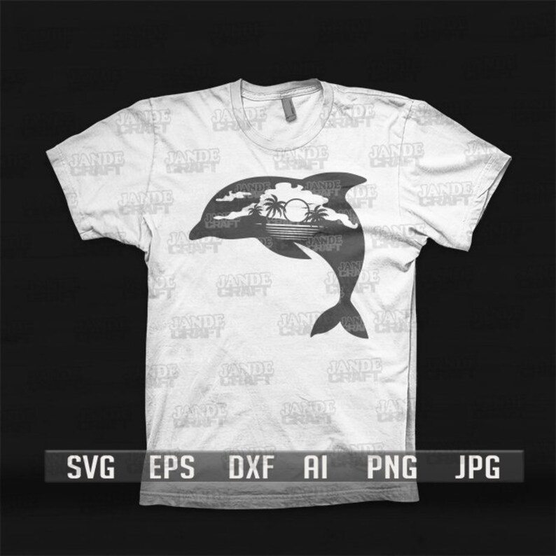 以下が含まれることがあります： 白いTシャツに、水から飛び出すイルカの黒いシルエットが描かれています。イルカの後ろにはヤシの木と太陽があります。Tシャツには「JADE CRAFT」という文字が繰り返しプリントされています。