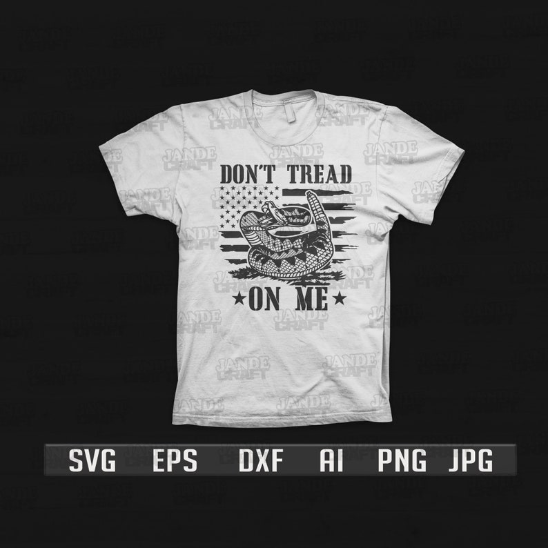 May include: A white t-shirt with a black and white graphic design. The graphic features a rattlesnake coiled around an American flag with the text "Don't Tread On Me".
