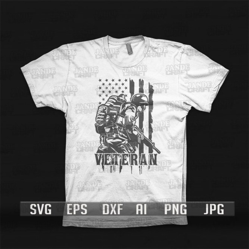 May include: A white t-shirt with a black and white graphic of a soldier standing in front of an American flag. The text "VETERAN" is printed below the soldier.