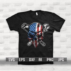 May include: A black t-shirt with a graphic of a skull with an American flag design. The skull is surrounded by two crossed wrenches.