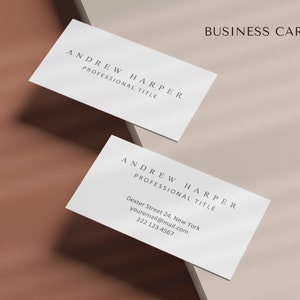 May include: A white business card with the text "ANDREW HARPER" and "PROFESSIONAL TITLE" in black font. The card also includes contact information: "Dexter Street 24, New York", "youremail@mail.com", and "222 123 4567".