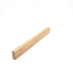 Könnte beinhalten: Ein rechteckiger, hellbrauner Holz-Schubladengriff.