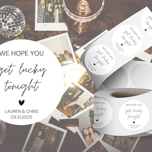 May include: A roll of round white stickers with black text that reads "We hope you get lucky tonight" with the date "03.21.2025" and the names "Lauren & Chris".