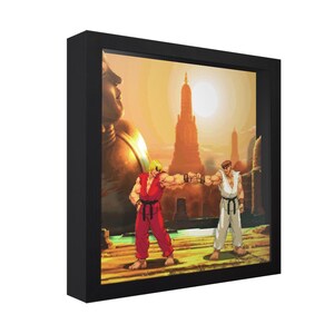 May include: A framed pixel art print featuring two characters from a fighting game, fist-bumping in front of a temple at sunset. One character wears red, the other white. The frame is black.
