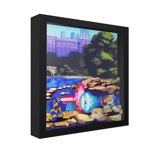 May include: A framed 3D shadow box featuring a pixelated scene of a video game battle. The artwork depicts two characters in action, with a cityscape and water in the background. The frame is black.