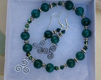 Gorgeous green Celtic inspired bracelet and earring set. Made with semi precious green apatite stone beads and Tibetan silver spacers