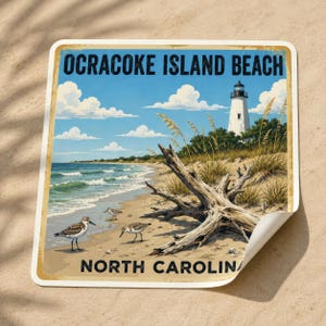 May include: A square sticker featuring a coastal scene of Ocracoke Island Beach, North Carolina. The image displays a white lighthouse, a large piece of driftwood on sandy dunes, and three small shorebirds walking along the water's edge.