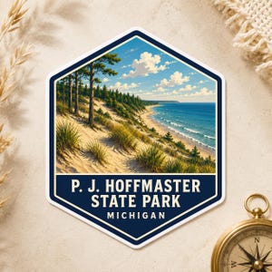 May include: A hexagonal sticker featuring a landscape illustration of P. J. Hoffmaster State Park in Michigan, showing sandy dunes with green grass and pine trees overlooking a blue lake under a bright sky with white clouds and bold text.