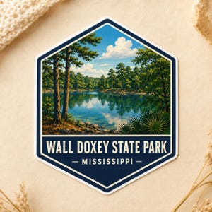 May include: A hexagonal sticker featuring a landscape illustration of Wall Doxey State Park in Mississippi. The scene depicts a calm lake surrounded by dense green pine trees under a blue sky with white clouds. The text reads WALL DOXEY STATE PARK.