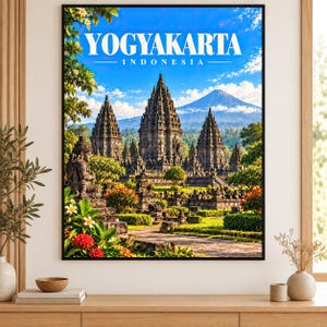 Könnte beinhalten: Ein gerahmter Wandkunstdruck, der den Prambanan-Tempelkomplex in Yogyakarta, Indonesien, zeigt. Das Bild zeigt steinerne Tempeltürme vor einem blauen Himmel und einem fernen Berg, mit üppigem grünem Laub und roten Blumen im Vordergrund.